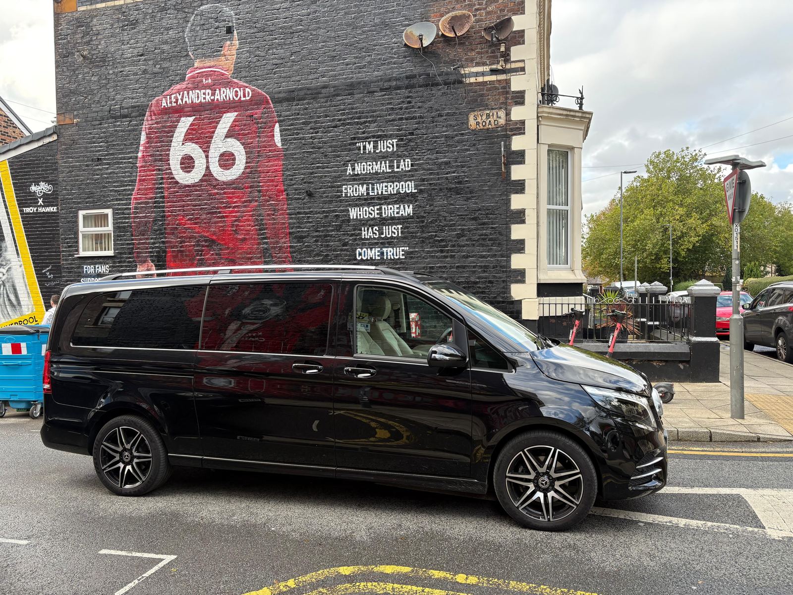 AO Platinum Chauffeurs V-Class beside the Trent Alexander-Arnold mural near Anfield, Liverpool
